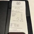 A West Side Steakhouse receipt listing shrimp cocktail, filet mignon, steak-house fries, creamed spinach, cheesecake and a Manhattan, with a $189.45 total.
